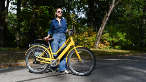 woman with a yellow step through bike